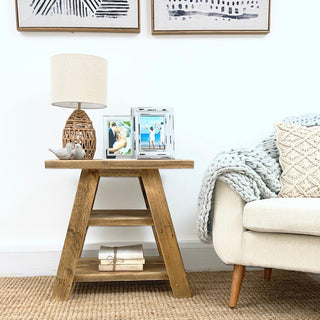 Add rustic charm to your living room with our reclaimed Yarmouth side table, featuring a shelf for storage. Crafted from solid, recycled wood, this small accent table exudes the warmth of natural wood and distressed finishes. 