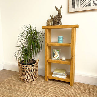 Step into rustic sophistication with the Winsor Solid Wood Narrow Rustic Bookshelf. This tall and narrow shelving unit is designed for both style and functionality, crafted from solid, natural wood to elevate your storage solutions.