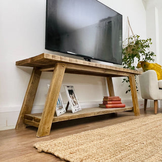 Introducing the Yarmouth Rustic Reclaimed TV Stand: Enhance your entertainment area with this handcrafted piece, offering open storage for larger audio equipment and adding rustic charm to your living space.