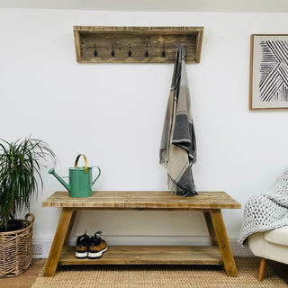 Introducing the Yarmouth Solid Wood Reclaimed Shoe Rack Bench: Handcrafted for both style and utility, this rustic piece offers a larger gap design, providing ample storage space for your footwear while adding charm to your entryway.