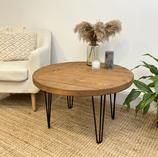 Discover the Hampton Handmade Rustic Round Industrial Coffee Table. Made from solid wood with metal hairpin legs, adding an industrial touch to your decor.