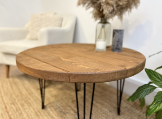 Discover the Hampton Rustic Round Industrial Coffee Table. Handcrafted from solid wood, featuring sleek metal hairpin legs for a modern touch.