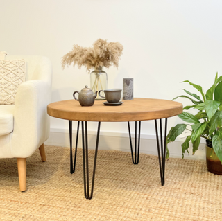 Explore the Hampton Handmade Rustic Round Industrial Coffee Table with metal hairpin legs. Crafted from solid wood, combining style and durability for your living space.