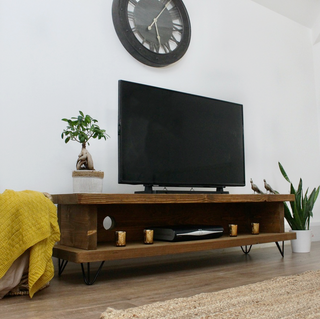 Presenting the Harland TV unit, an entertainment centerpiece for your living room. This rustic wooden TV unit features a shelf for storage, providing functionality and style.