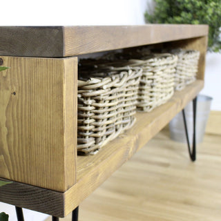 Add industrial charm to your hallway with the Holmestead console table. Crafted from rustic wood, it offers a stylish spot for keys and decor pieces.