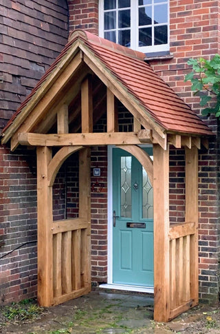 Introducing the Solid Oak Tulip Porch Kit: Elevate your home's curb appeal with this meticulously crafted porch, featuring green oak, mortice and tenon joints, and a rich linseed oil finish for enhanced natural beauty.